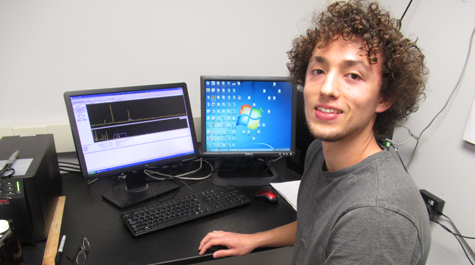 Paul Volante uses a computer to analyze decay events recorded in the gamma lab. 
