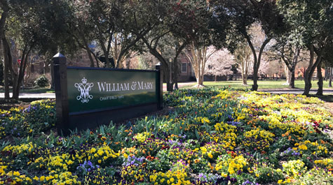William & Mary campus sign surrounded by spring flowers.