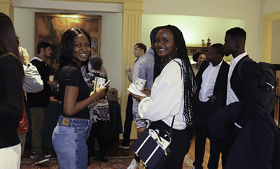 Araba with Solange Umuhoza '22, currently a first year M.S. student in Computer Science, at the spring semester reception for the international community. Shakia is in the background on the right, working the event, as always. (Photo by Kate Hoving)