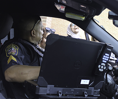 Sergeant Edgar Jones demonstrates the technology available in police vehicles