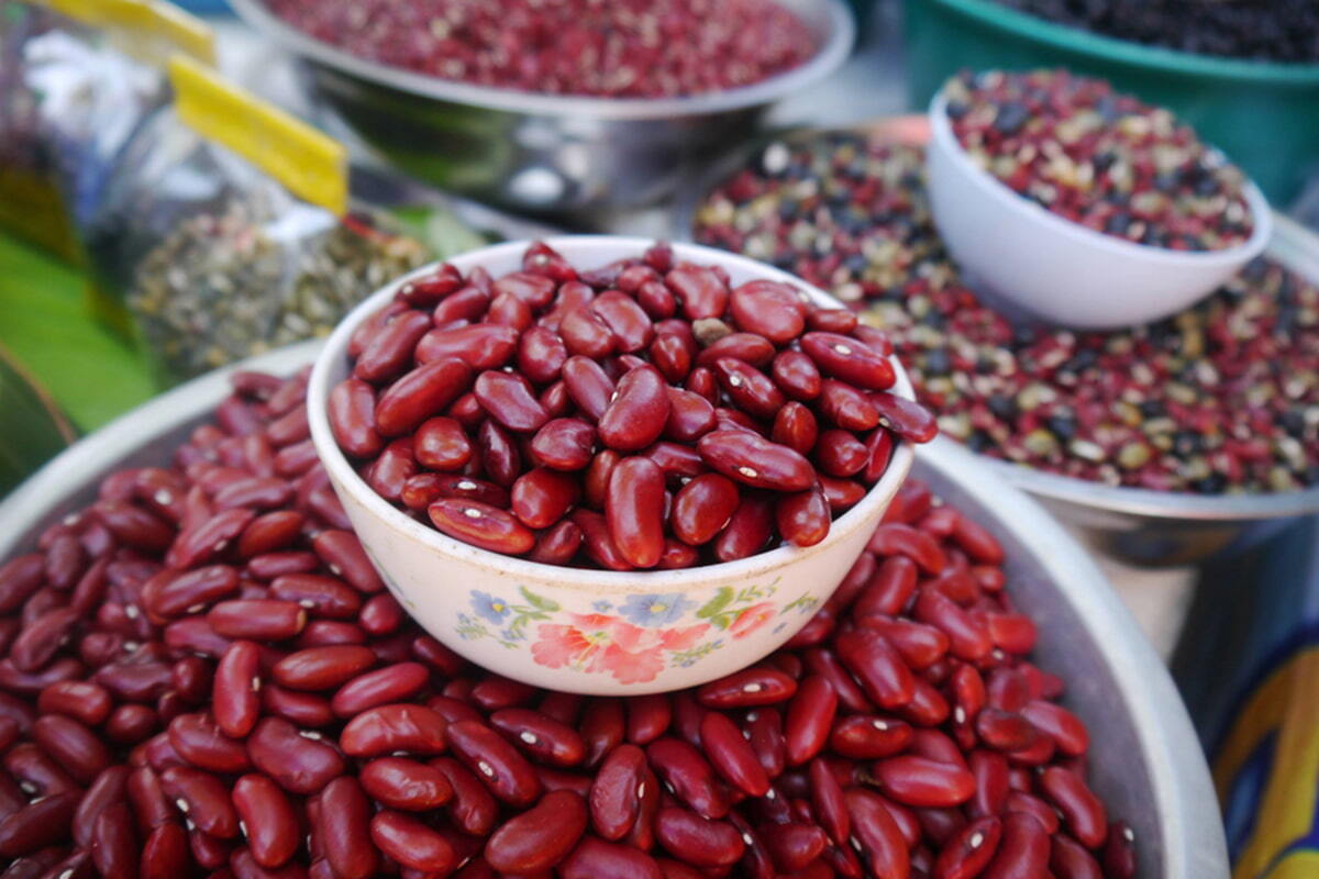 Stacked bowls of red and multi-colored beans.