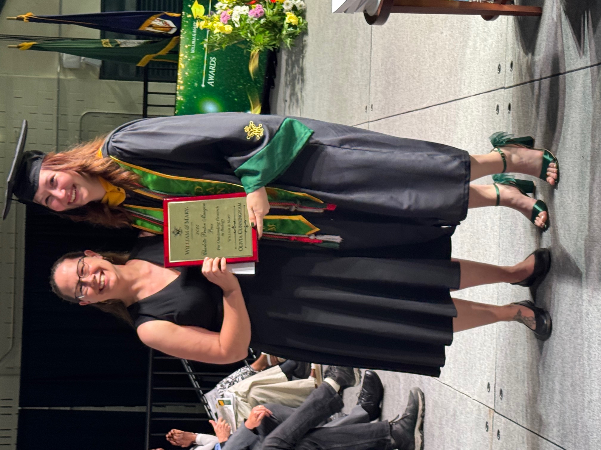 Olivia Cunningham ’25 (with Dr. Harmony Dalgleish) poses with her Charlotte Preston Mangum Prize plaque at the Biology Graduation Ceremony.