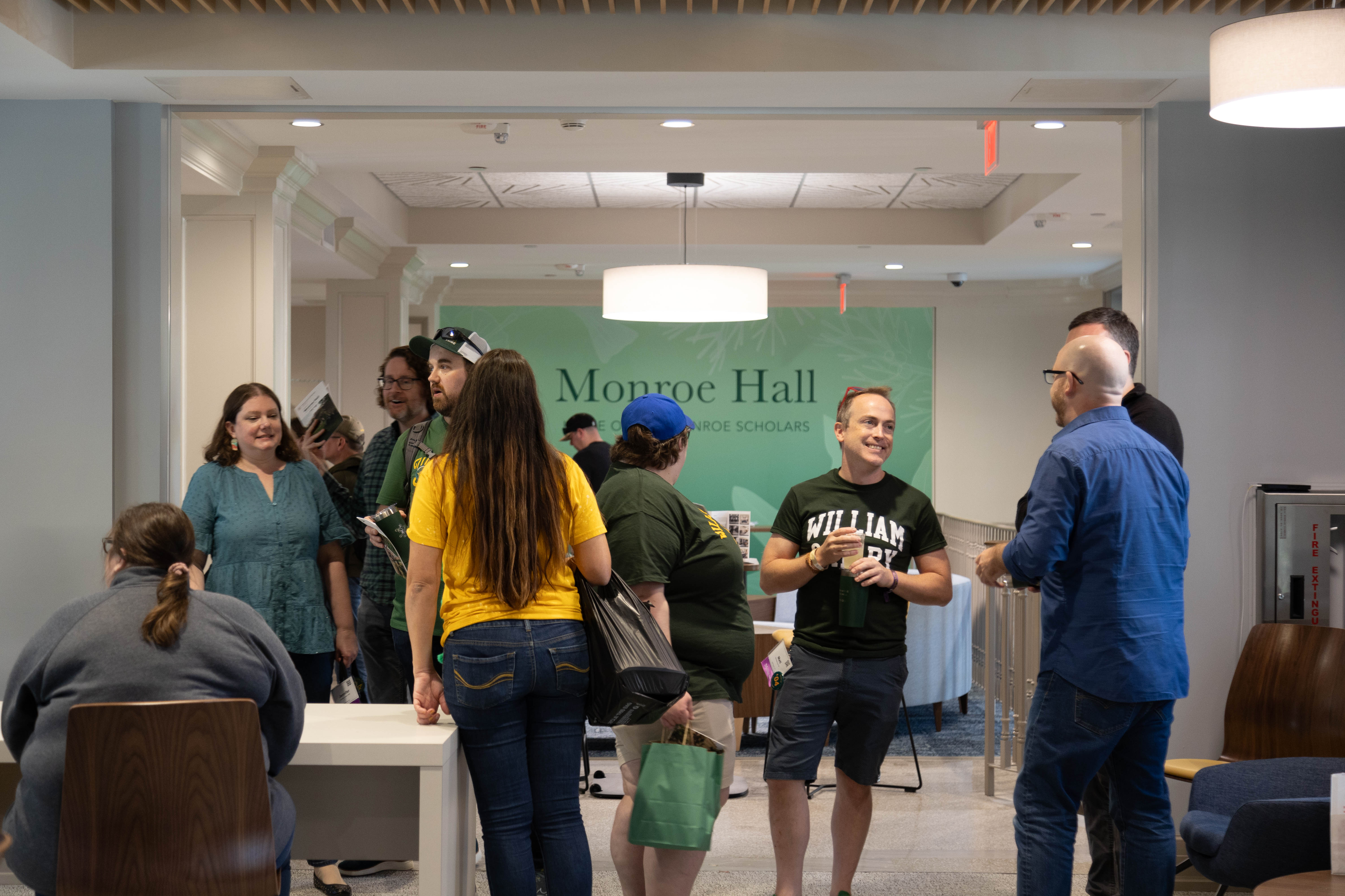 The Monroe Hall rededication ceremony drew several hundred students, faculty, and alumni, many adorned in green and gold for Homecoming weekend festivities. (Photo by Tess Willett)  