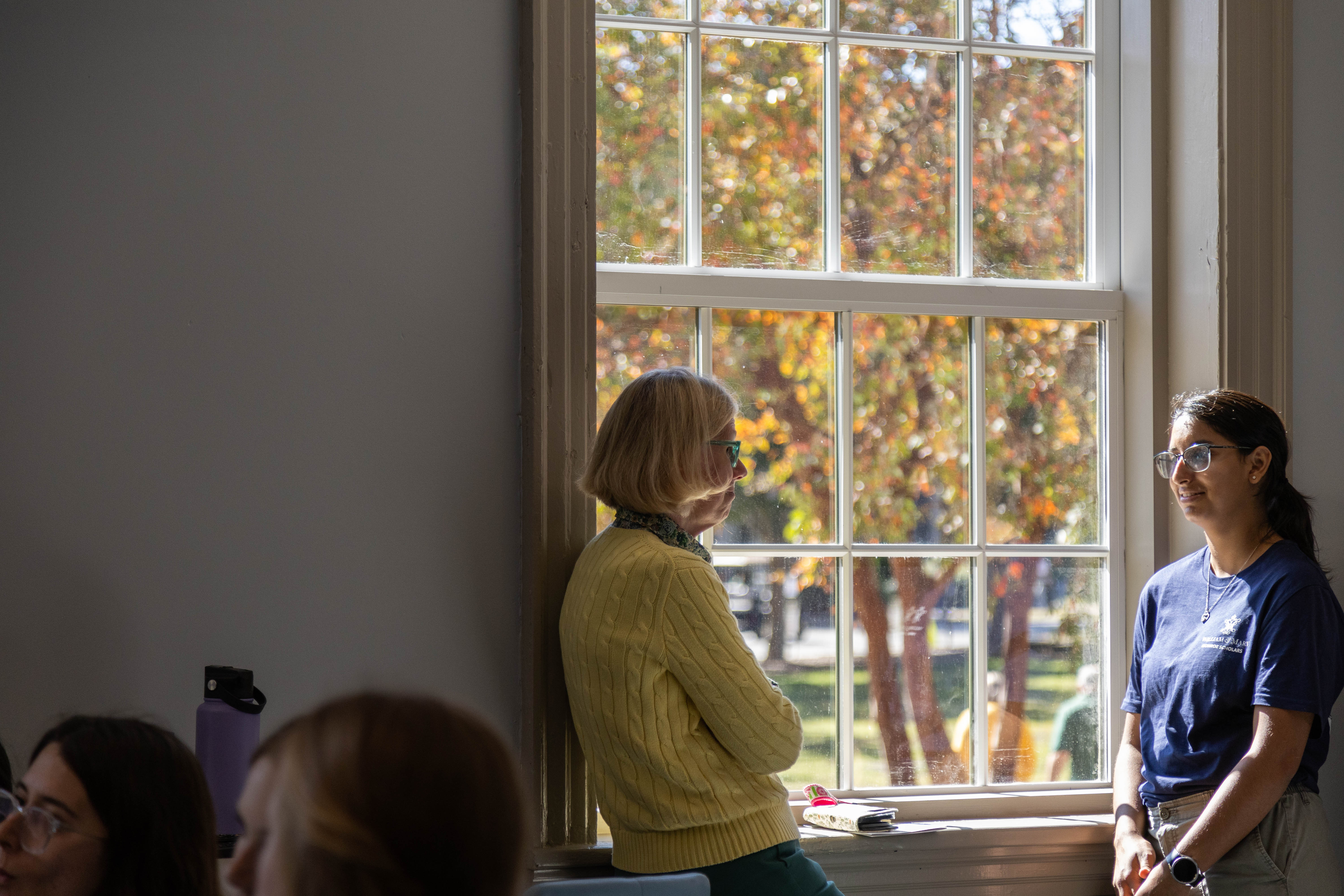 Charles Center Program & Events Coordinator Lauri Dabbieri (left) and Monroe Scholars Program Student Assistant Aditi Mishra '27 (right) reflect on the role Monroe Hall has played in fostering community and connections among its first-year residents. (Photo by Tess Willett)