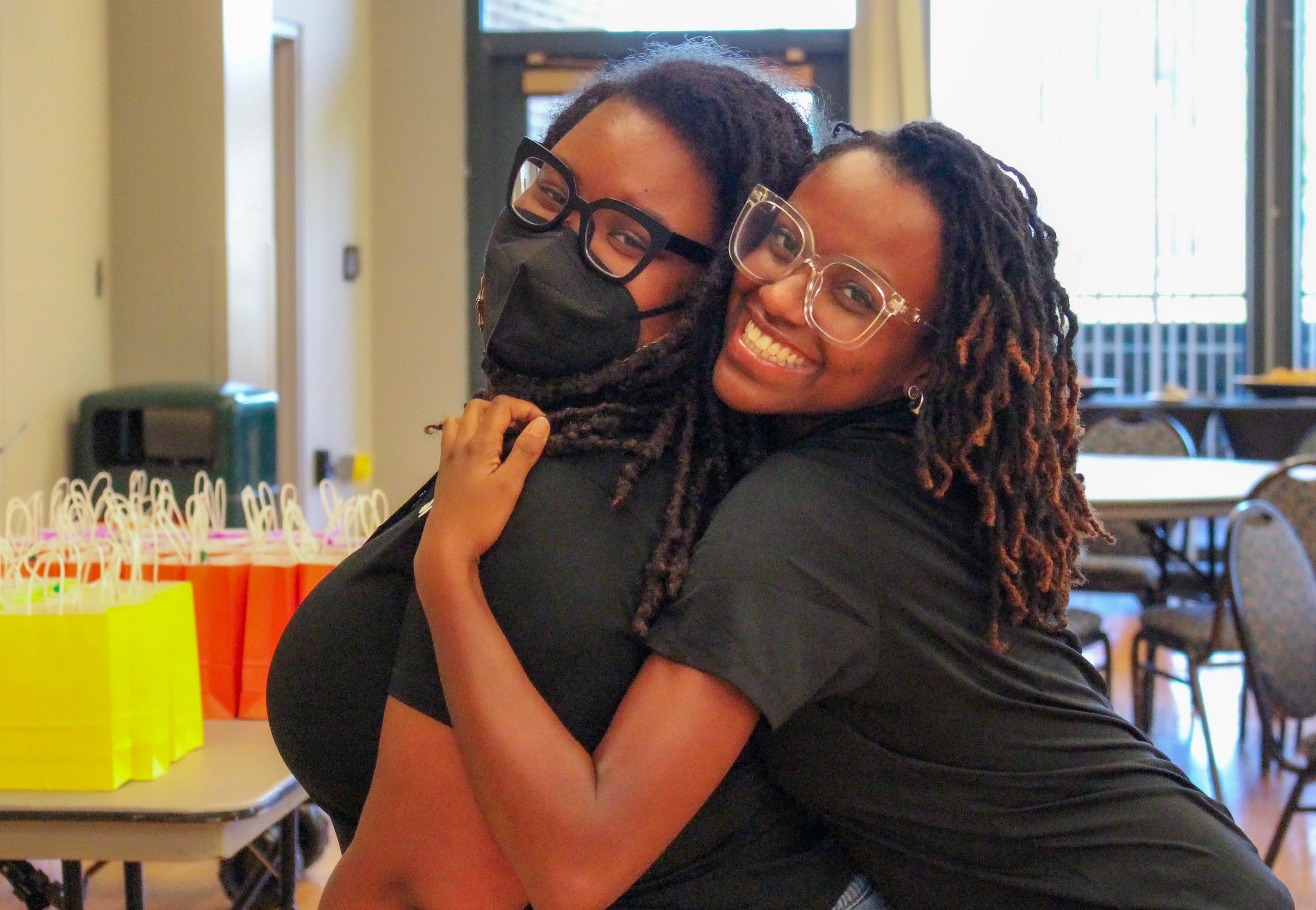 Alston (left) and WMSURE graduate assistant Raven Pierce '24 (right) help set up the annual WMSURE Research Conference last April in Sadler. (Photo by Emmanuel Sampson)