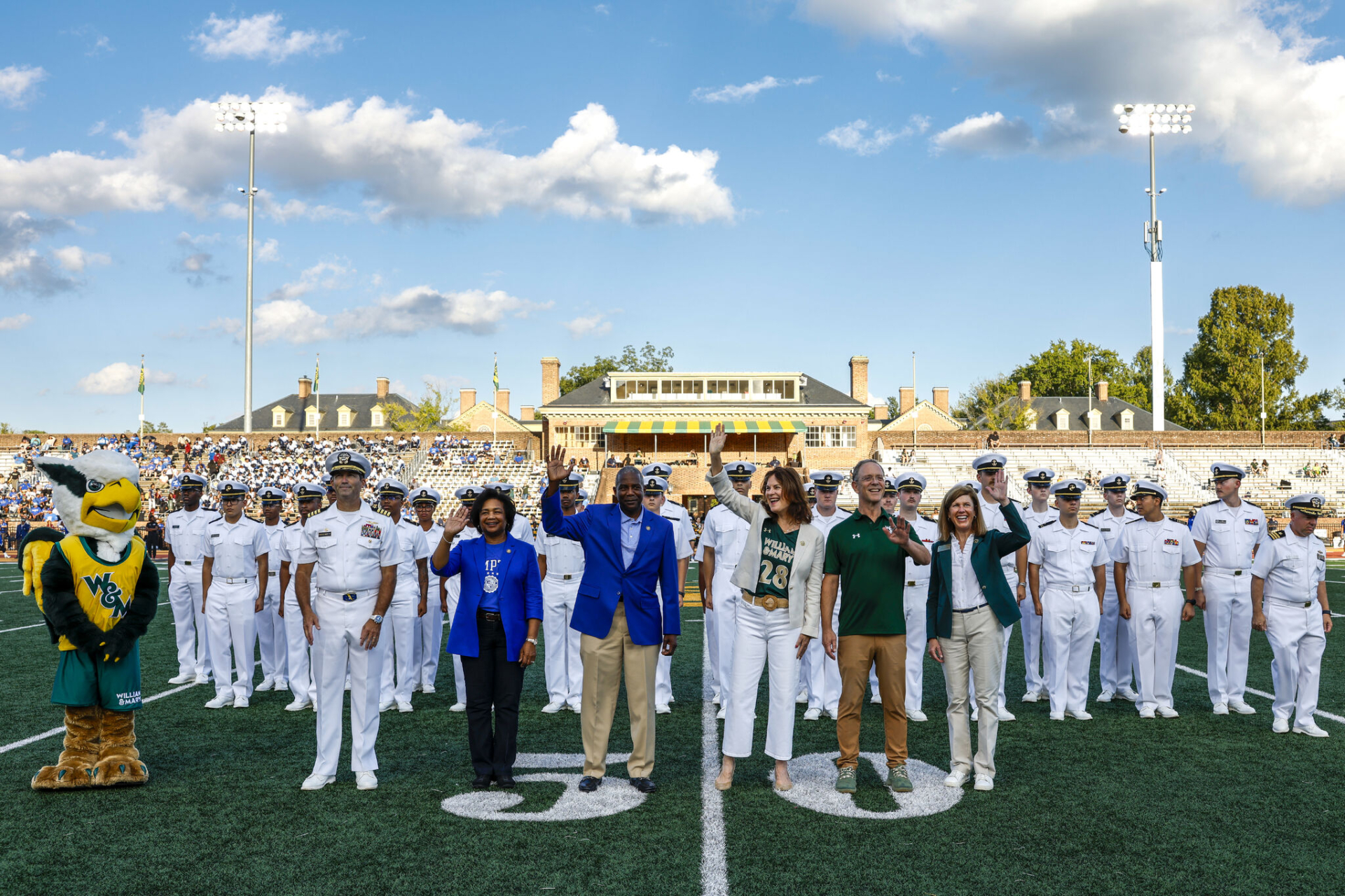 President Rowe and others from the Naval ROTC program gathered on the field at a William & Mary football game