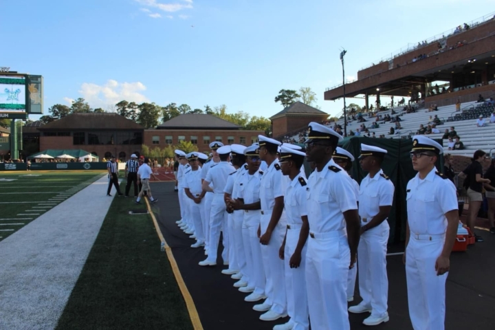 Students from the Naval ROTC program gathered on the field at a William & Mary football game