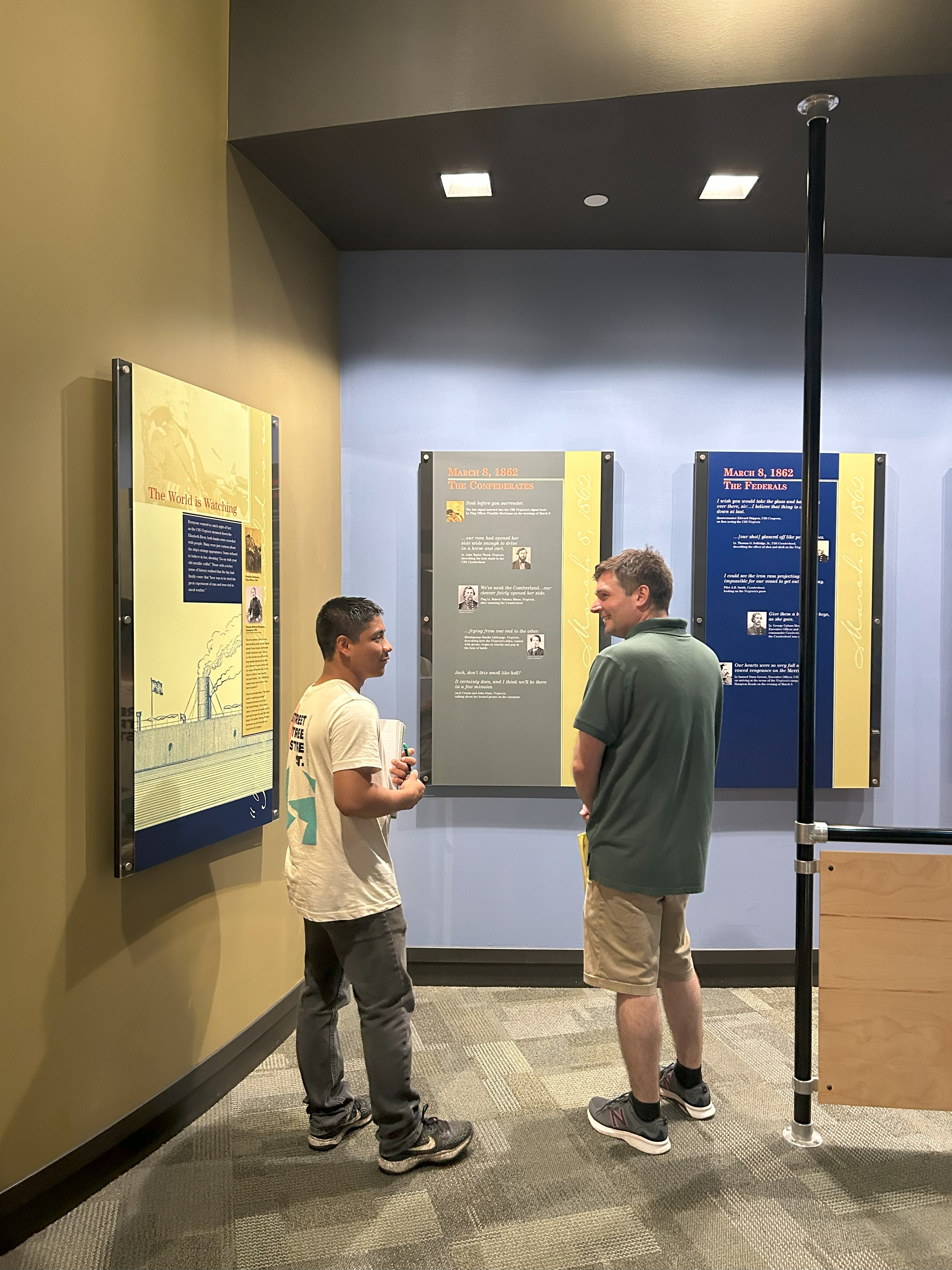  Mark Guerci ’11, M.A. ’15, Ph.D. ’21 talks with a pre-college student during class at the Mariners' Museum