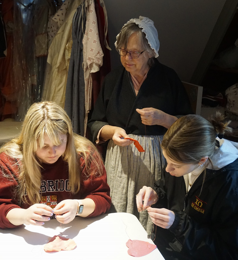 Students studying with the Colonial Williamsburg Milliners