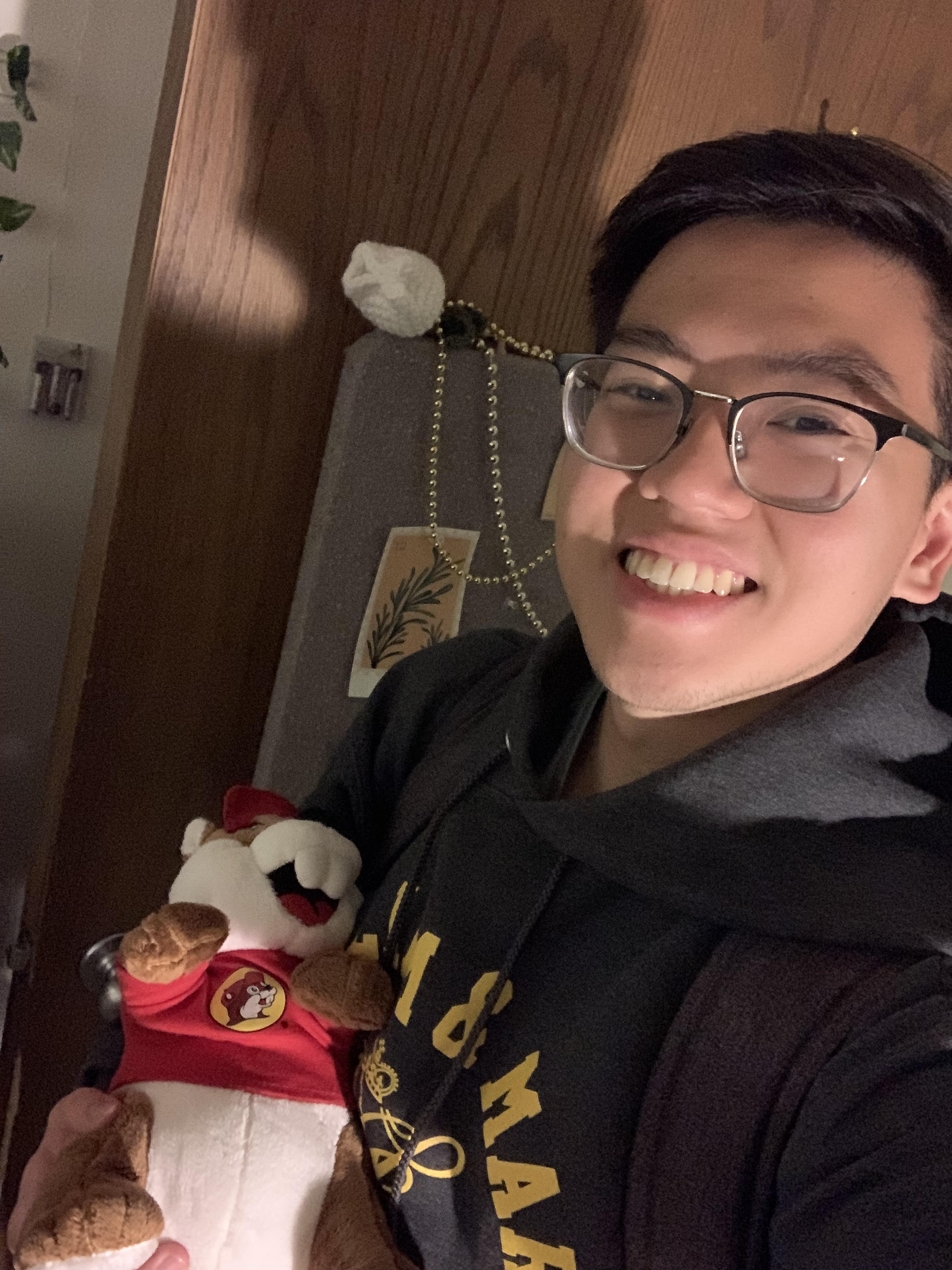 A photo of Jason Zheng holding a stuffed animal