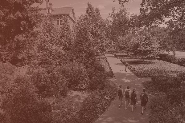 Students walking along a brick path