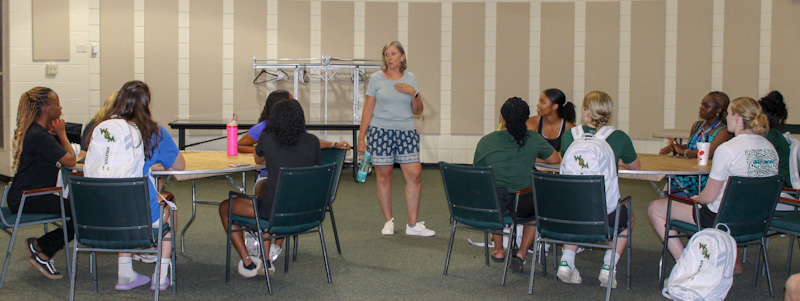 Cyndy Huddleston speaks with the fellows and players.