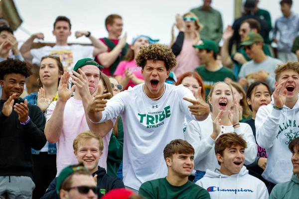 Students energetically cheering at a Tribe football game