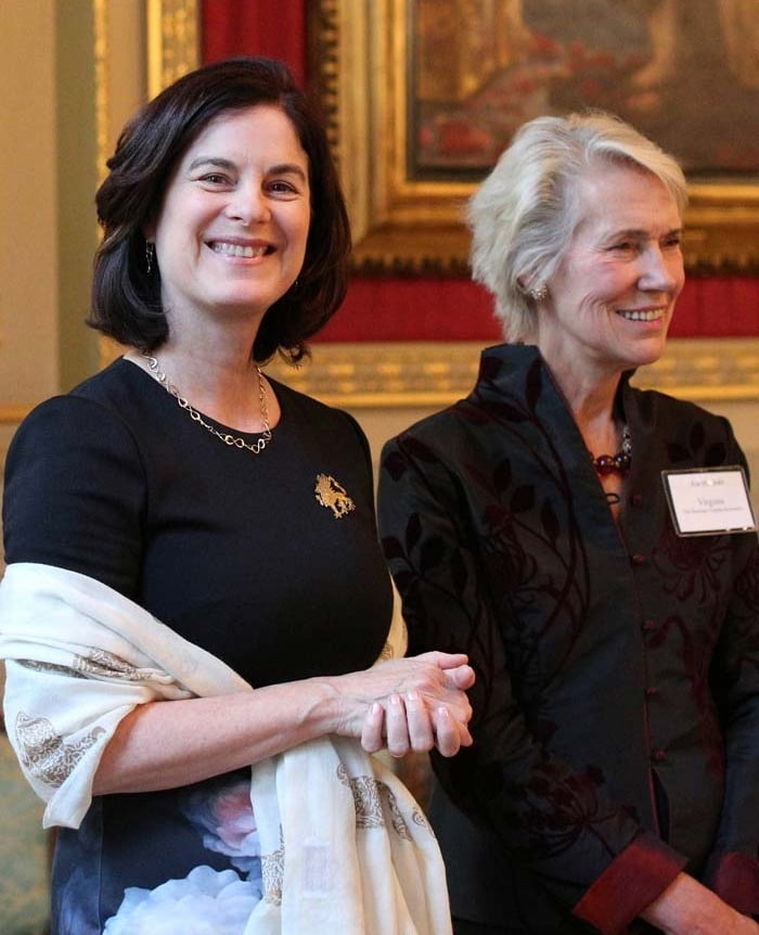 President Katherine A. Rowe in front of a large gilded frame