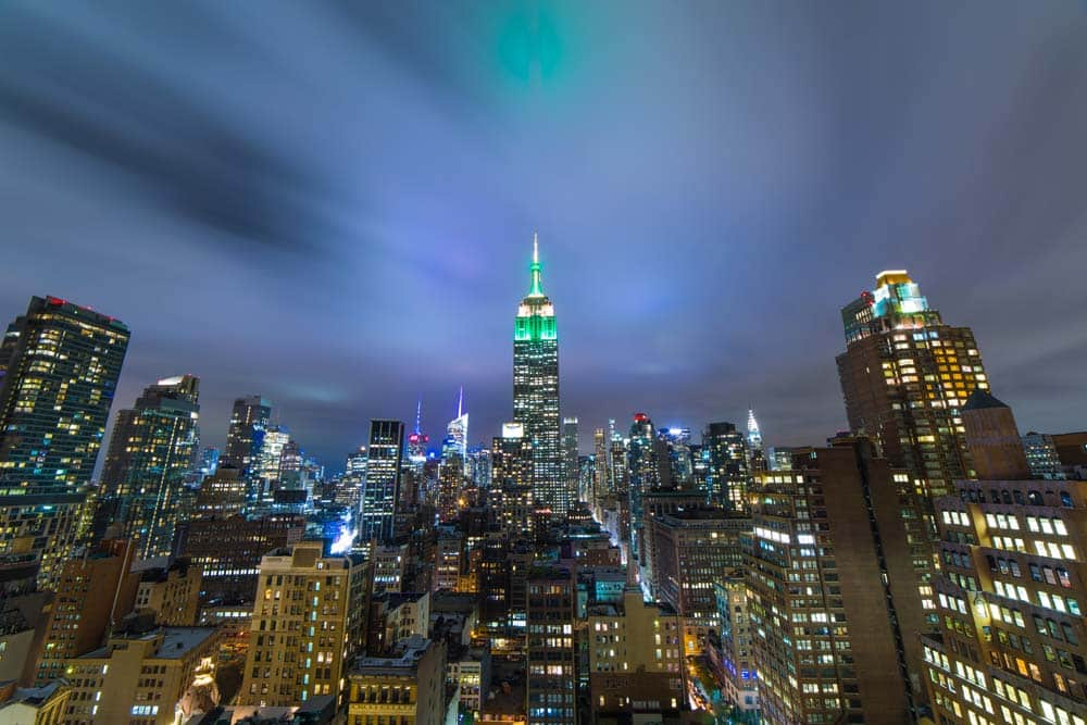 New York City skyline with the Empire State Building lit in green and gold