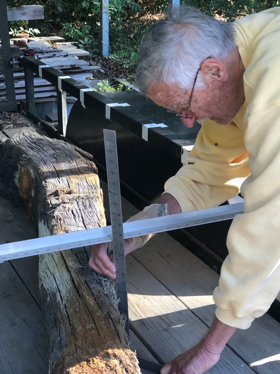 Maritime archaeologist measuring ship timbers recovered from the HRBT expansion's dredging.